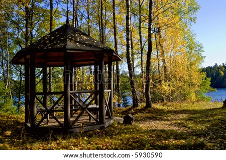 Wooden pavilion in the autumn garden