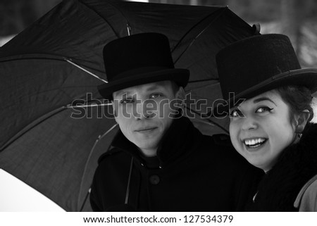 Shaded man and happy woman under common umbrella