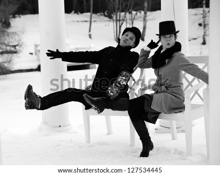 Shaded man and woman worming at white chairs