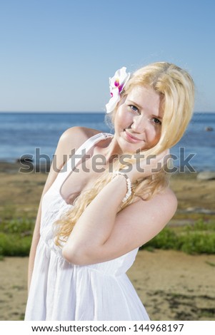 Blushing woman with white flower in gold hairs