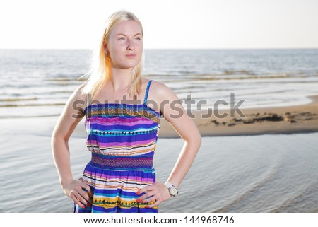 Woman woman in lined dress on sea shore