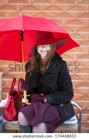 Happy woman on bench at cold winter day