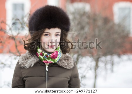 Female brunette with a wind running through her hair