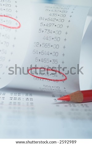 roll paper, list of numbers, some numbers encircled with a red pencil. Shot in studio with Phase One.