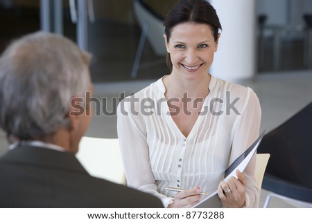 Smiling female consultant talking with a client