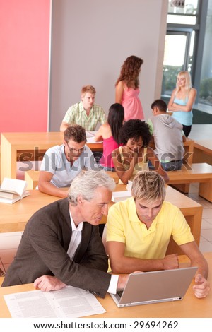 Portrait of happy student with lecturer in a classroom