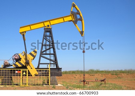 oil pump jacks working at dawn. A pump jack on the plains