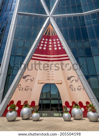 CALGARY, CANADA - JULY 13: The Bow Tower decorated for the Calgary Stampede on July 13, 2014 in Calgary, Alberta Canada. Here the exterior of the Bow is decorated with a Blackfoot Indian Tepee.