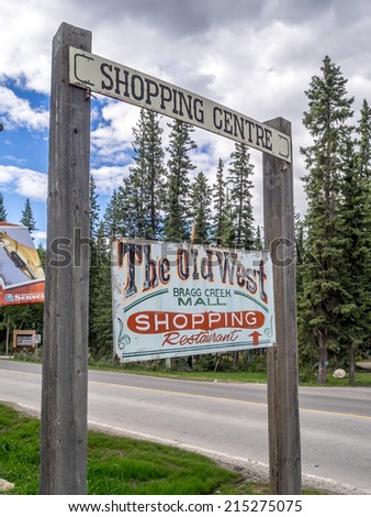 BRAGG CREEK, CANADA - SEPT 4: Old rustic sign for the Old West Shopping Mall on September 4, 2014 in Bragg Creek, Alberta, Canada. The Old West Shopping Mall is a tourist attraction in Bragg Creek.