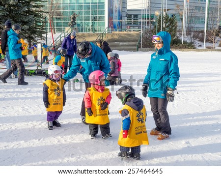 CALGARY, CANADA - MAR 1: Kids learning to ski at Canada Olympic Park om March 1, 2015 in Calgary, Alberta Canada.  Visible are toddlers in a pre-school skiing class.