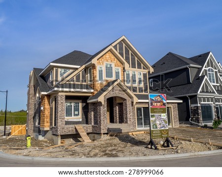 CALGARY, CANADA - MAY 17: Westview show home under construction in Aspen Woods on May 17, 2015 in Calgary, Alberta. This Westview show home is typical of upscale Calgary suburban communities.