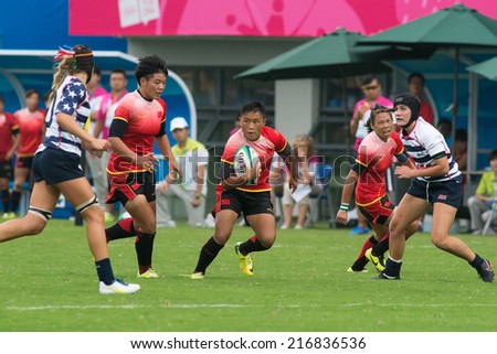 NANJING, CHINA-AUGUST 18: USA Rugby Team (white/blue) plays against China Rugby Team (red) during Day 2 match of 2014 Youth Olympic Games on August 18, 2014 in Nanjing, China.