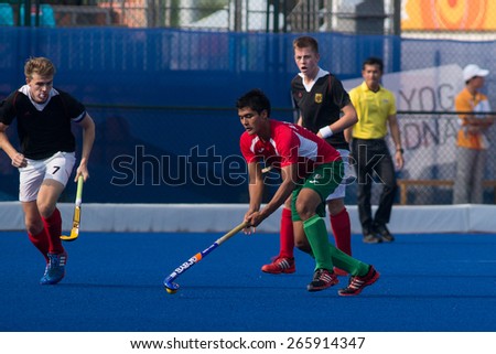 NANJING, CHINA-AUGUST 21: Mexico Hockey Team (red) plays against Germany Hockey Team (black) during Day 5 match of 2014 Youth Olympic Games on August 21, 2014 in Nanjing, China.