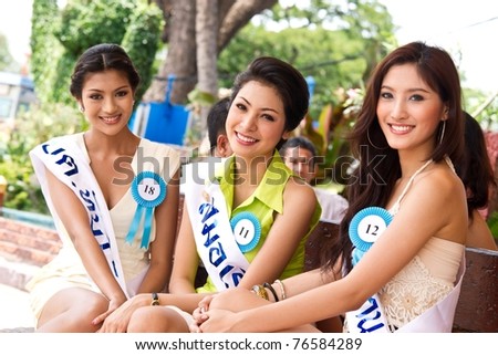 HUA HIN THAILAND - APRIL 29: Three unidentified Miss Hua Hin Contestants pose for camera in round 1 of 2011 Miss Hua Hin Beauty Contest on April 29, 2011 at Hua Hin Train Station in Hua Hin, Thailand
