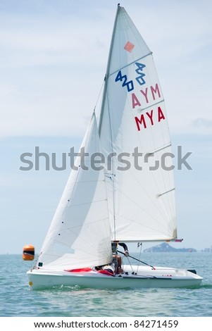 CHA-AM, THAILAND - AUGUST 22: An unidentified sailor from Myanmar competes during Day 1 of the 2011 Hua Hin Regatta on August 22, 2011 at Dusit Thani Resort & Spa Hua Hin in Cha-Am, Thailand