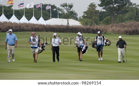 CHONBURI, THAILAND - DECEMBER 15: A group of golfers and caddies walk towards hole 1 during Day 1 of Thailand Golf Championship on December 15, 2011 at Amata Spring Country Club in Chonburi, Thailand