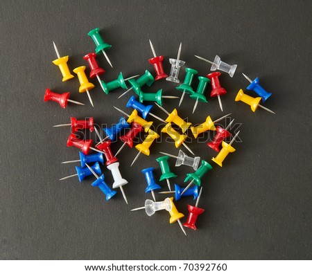 The drawing pins on a black background