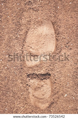 The imprint of the soles on the sandy road