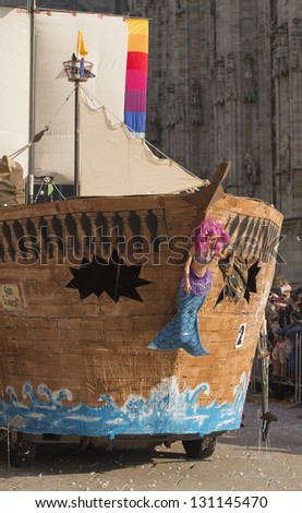 MILAN, ITALY - FEBRUARY 16: a pirate boat float in parade, in background blurred Minster. Shot at Kid\'s Carnival parade on Minster square on feb 16, 2013 Milan, Italy