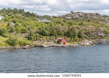 fjord landscape with warehouse and spaced out houses on green fjord shore, shot under bright summer light at Karbo, Norway Zdjęcia stock © 