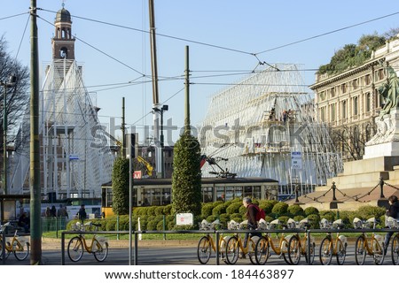 MILAN, ITALY - MARCH 6: view of the building site of EXPO 2015  tourist information center near Castello Sforzesco, in fore ground bike-sharing bikes and a trolley car; shot mar 6 2014,  Milan, Italy