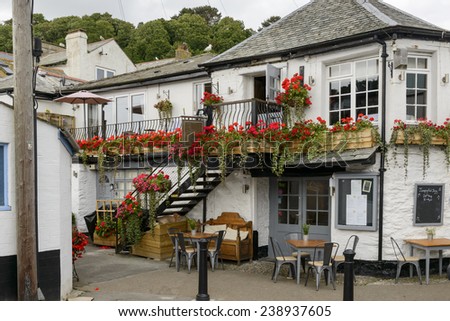 old blossoming pub at Looe, Cornwall, view of  old house covered with flowers with a pub inside, shot in the village on southern coast of Cornwall