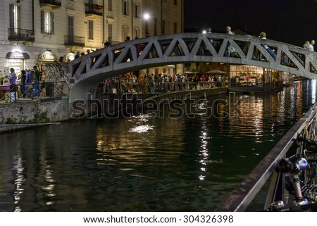 MILAN, ITALY - July 31: night life in city center at EXPO time, motion blurred people walk on old pedestrian bridge at old canal  at night , shot  on  jul 31 2015  Milan, Italy