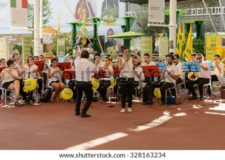 MILAN, ITALY - August 05: EXPO 2015,  a music band plays in the shade of the second main walk at exhibition, shot  on aug 05 2015  Milan, Italy