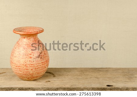 Ceramic vase on old wood