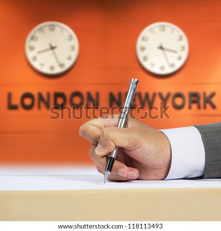 Businessman signing document and time