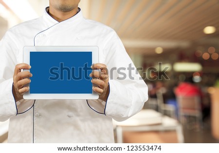 Chef showing a digital tablet in the restaurant
