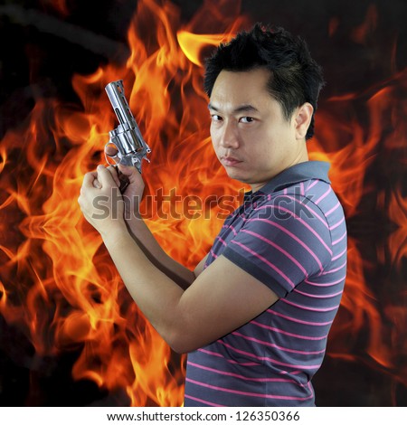Man holding gun with fire background