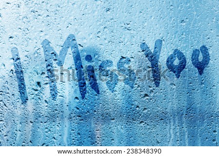Rain on glass with I miss you text