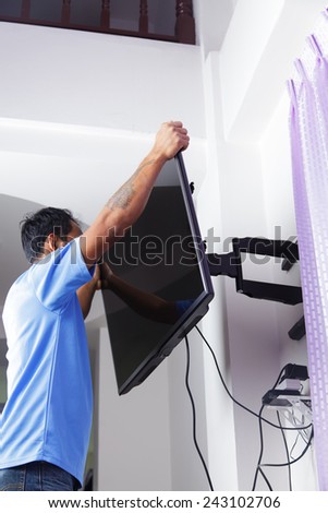 Installing mount TV on the wall at home or office