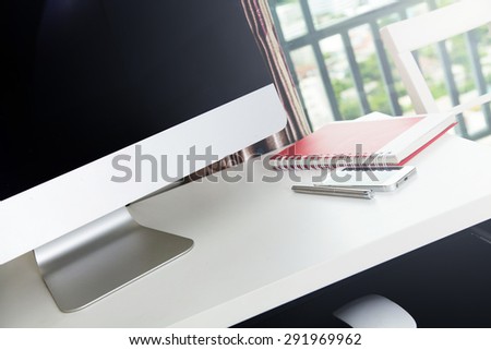 Computer on Home Office with phone and notebook