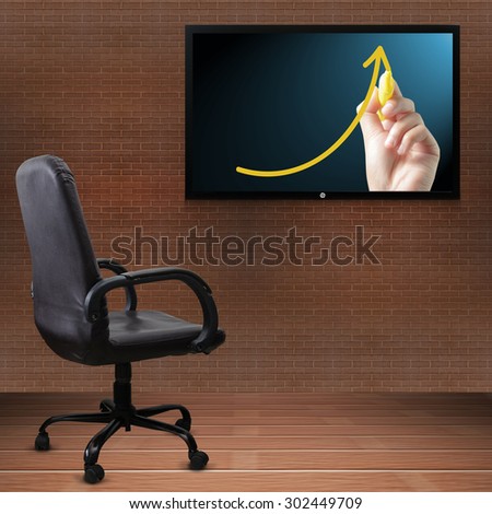 Office chair and TV screen with business graph