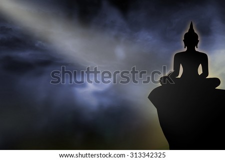 Silhouette of Buddha statue at night sky abstract background