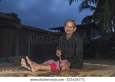 Smiling elderly people on countryside home background in thailand