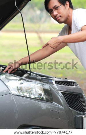 The young man checked the car before you leave