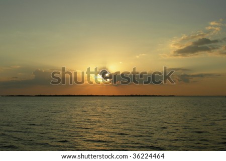Orange calm sunset on the Rio Negro in the Amazon River basin, Brazil, South America