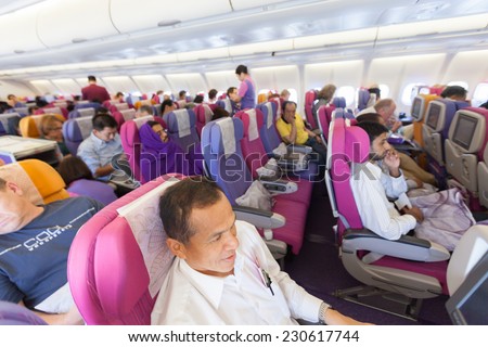 BANGKOK, THAILAND - OCTOBER 27: flight crew and passengers on board an Thai Airways flight from Suvarnabhumi Airport to Yangoon Airport on October 27, 2014