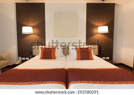 CHA-AM, THAILAND - JUNE 18: Double bed hotel room with lamps turn on in Spring Field at Sea hotel in Cha-am, Thailand during 19 June, 2015