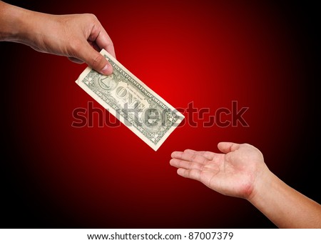 Two people passing  dollar bill from hand to hand
