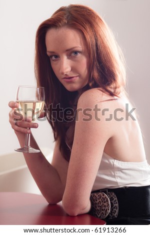 Attractive young lady with a glass of wine