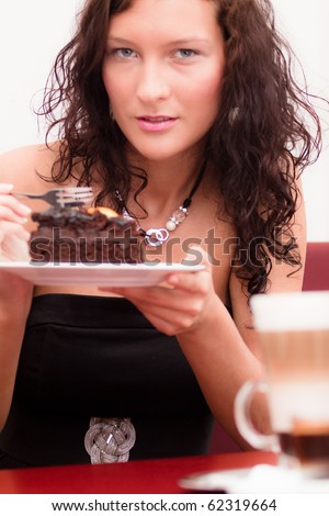 Nice dark-hair women with a chocolate cake