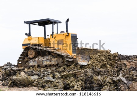 Bulldozer machine doing earth moving work in construction site