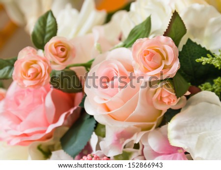 Orange fabric roses,Fake textile orange roses close-up floral background
