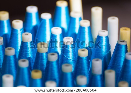 Bobbin for weaving silk,Spool of blue silk thread in row
