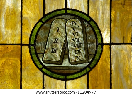 Stained glass window in a medieval church showing the 10 commandment tablets