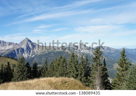 Mountain world in Tyrol, Austria; mountains, rugged rocks, valleys and mats, blue sky with white clouds/Idyllic mountain world in Tyrol, Austria